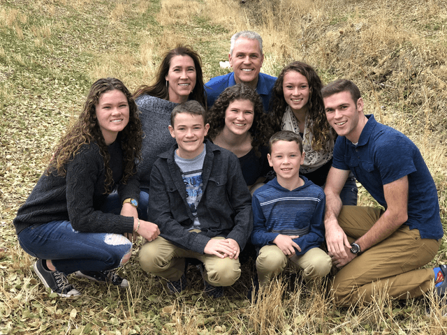 Dr. Charles Smurthwaite with his wife and seven children outdoors
